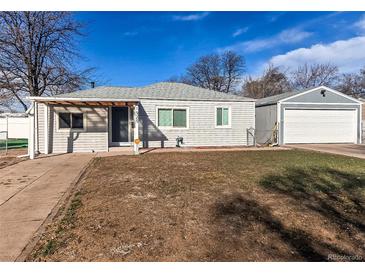 Charming single-story home with a detached garage and an expansive front yard in a suburban setting at 1925 S Irving St, Denver, CO 80219