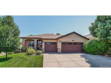 Charming single-story home featuring a well-manicured lawn and a two-car garage at 8582 E 148Th Ln, Thornton, CO 80602