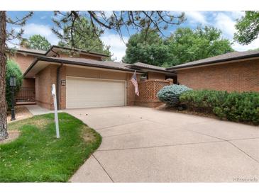 Brick ranch home with attached garage and landscaped yard at 6100 W Mansfield Ave # 24, Denver, CO 80235