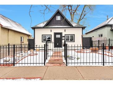 Charming home featuring a black fence, complemented by a black-and-white exterior paint scheme at 1724 W 40Th Ave, Denver, CO 80211