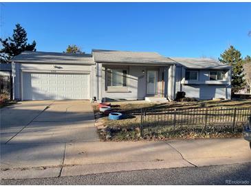 Charming single-story home with an attached two-car garage and well-kept front yard at 16289 E Wagontrail Dr, Aurora, CO 80015