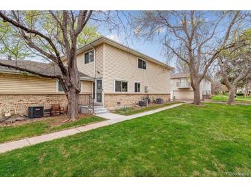 Inviting townhome with brick facade, landscaped yard, and a quaint front entrance at 9195 E Lehigh Ave # 162, Denver, CO 80237