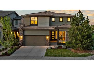 Charming two-story home featuring a stone-accented facade, well-maintained landscaping, and a convenient two-car garage at 481 Meadowleaf Ln, Highlands Ranch, CO 80126