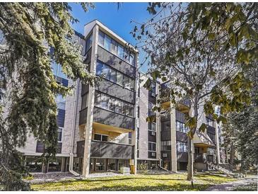 Modern condo with black balcony bars and a view of trees at 6940 E Girard Ave # 307, Denver, CO 80224