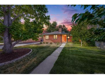 Charming brick home boasts a lush lawn, mature trees, and inviting walkway at 4850 E Dartmouth Ave, Denver, CO 80222