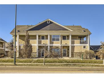 Tan two-story condo building with stone accents and balconies at 8200 E 8Th Ave # 2102, Denver, CO 80230