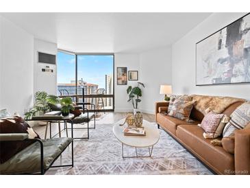 Bright living room featuring modern decor, large windows with city views, and stylish furnishings at 1625 Larimer St # 1806, Denver, CO 80202