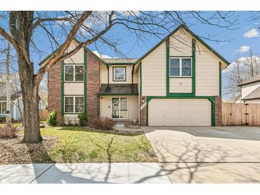 Charming two-story home with brick accents, a two-car garage, and a well-maintained front yard at 12258 E Lasalle Pl, Aurora, CO 80014