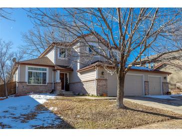 Two-story house with a two-car garage and landscaping at 4236 Lark Sparrow St, Highlands Ranch, CO 80126