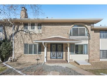 Brick ranch home with a covered entry and mature landscaping at 3257 S Pontiac St, Denver, CO 80224