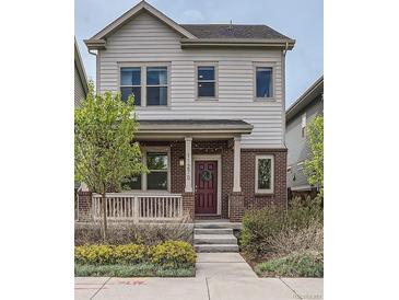 Charming two-story home boasts brick accents, a cozy front porch, and well-manicured landscaping at 11270 E 26Th Ave, Aurora, CO 80010