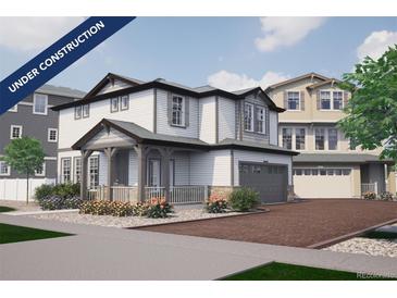 Charming two-story home featuring a covered porch, attached garage, and beautifully landscaped front yard at 1194 Sugarloaf Ln, Erie, CO 80516