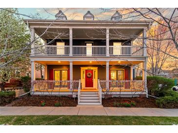 Charming two-story home featuring a covered front porch and balcony at 2843 Havana St, Denver, CO 80238