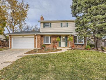 Brick two-story house with attached garage and landscaped yard at 824 S Nelson Way, Lakewood, CO 80226