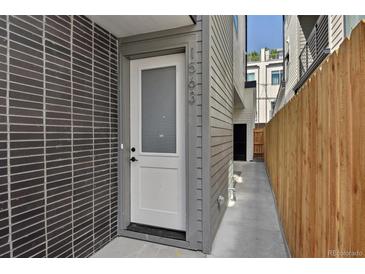 Modern home featuring a white front door with address number at 1563 N Hooker St, Denver, CO 80204