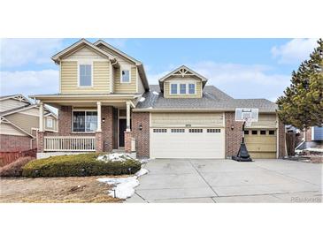 Charming two-story home with a brick and siding facade and attached two-car garage at 2835 S Jebel Way, Aurora, CO 80013