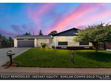 Charming exterior showcasing the well-manicured lawn and attached garage, enhanced by a beautiful twilight sky at 13010 W 6Th Pl, Golden, CO 80401