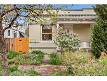 Charming bungalow with a well-maintained front yard and inviting facade at 2339 Lowell Blvd, Denver, CO 80211