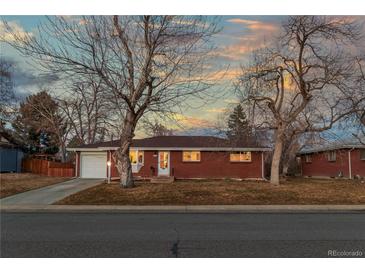 Charming single-story brick home featuring mature trees and a well-maintained front yard at 6532 S Ogden St, Centennial, CO 80121