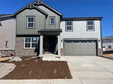 Two-story home with gray and stone facade, two-car garage, and newly landscaped front yard at 22057 E 39Th Pl, Aurora, CO 80019