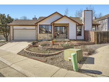 Charming home features a well-manicured front yard and a two-car garage, enhancing curb appeal and functionality at 10443 W 84Th Pl, Arvada, CO 80005