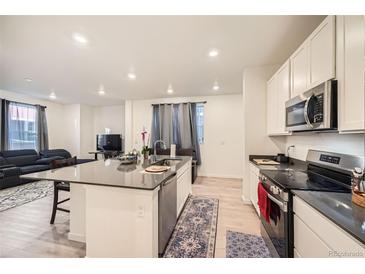 Modern kitchen with island, stainless steel appliances, and ample counter space at 677 Brookwood Dr, Lafayette, CO 80026