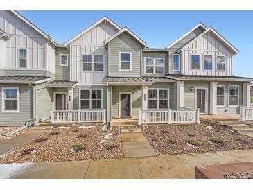 Two-story townhome with light green siding, white trim, and a small front yard at 1926 S Haleyville Way, Aurora, CO 80018