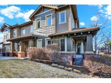 Charming home featuring a mix of shake siding, brick accents, and inviting front porch at 10112 Bluffmont Ln, Lone Tree, CO 80124