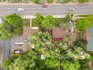Aerial view of a property with mature trees next to a busy thoroughfare at 25 S Wadsworth Blvd, Lakewood, CO 80226
