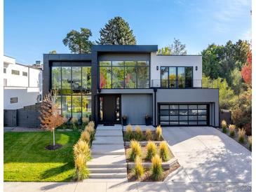 Stunning modern home with sleek design, large windows, and meticulously landscaped front yard at 42 S Ash St, Denver, CO 80246