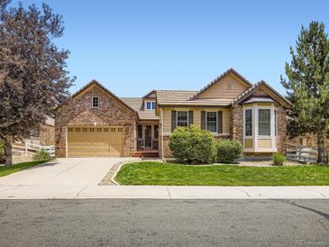 Charming brick home featuring a meticulously maintained front lawn at 14310 Kalamath St, Westminster, CO 80023