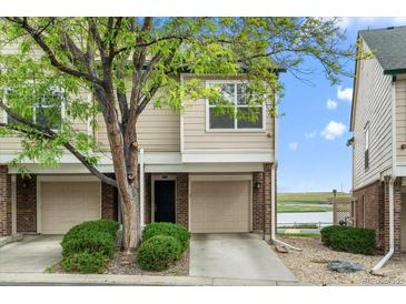 Inviting townhome featuring a private garage, well-maintained landscaping, and proximity to a tranquil lake at 1631 Egret Way, Superior, CO 80027
