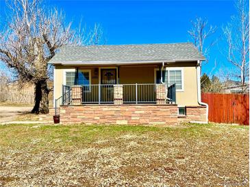 Charming single-story home featuring a quaint porch and brick accents at 2561 W Dartmouth Ave, Denver, CO 80236