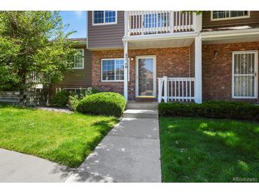 Inviting brick and siding townhouse with well-maintained lawn and garden at 4574 S Cimmarron Cir # B, Aurora, CO 80015