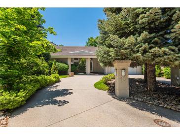 Stunning single-story home with a lush landscaped front yard and circular driveway at 400 S Steele St # 13, Denver, CO 80209