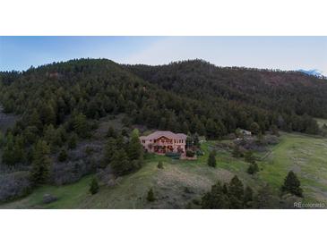 Secluded mountain estate featuring mature trees, open meadows, and stunning mountain views at 15533 S Perry Park Rd, Palmer Lake, CO 80133