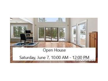 Bright living room with expansive windows offering stunning outdoor views, perfect for relaxation at 27987 Pine Grove Trl, Conifer, CO 80433