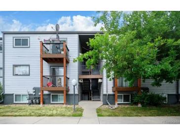 Multi-level apartment building with wood balconies and well-maintained landscaping at 16259 W 10Th Ave # J5, Golden, CO 80401