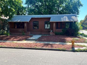Charming brick duplex with individual entrances and well-maintained front yards at 292 S Lafayette St, Denver, CO 80209