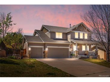 Inviting two-story home with a three-car garage and charming front porch, perfect for relaxing at 3761 S Orleans St, Aurora, CO 80013