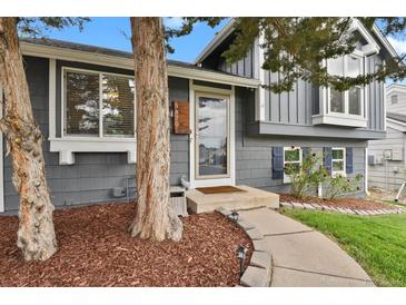 Charming home featuring a welcoming front entrance with meticulous landscaping and a cozy walkway at 5870 S Perth Pl, Centennial, CO 80015