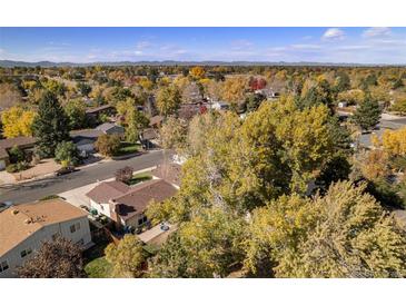 Expansive aerial view of a neighborhood showcasing mature trees and charming homes on a sunny day at 3164 S Nucla St, Aurora, CO 80013