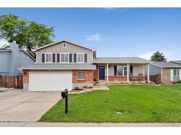 Charming two-story home with a well-manicured front yard and a two-car garage in a suburban setting at 11021 Otis St, Westminster, CO 80020