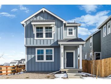 Two-story house with gray siding, a dark gray door, and a small front yard at 2060 Chambers Rd, Brighton, CO 80601