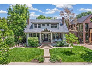 Charming home with a well-maintained front yard, mature trees, and a welcoming front porch at 2324 S Columbine St, Denver, CO 80210