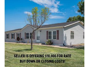Charming single-story home featuring a well-maintained lawn and classic vinyl siding at 8260 County Road 39, Fort Lupton, CO 80621