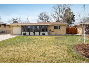 Charming home featuring a well-maintained lawn and an inviting enclosed porch at 169 Emerald St, Broomfield, CO 80020