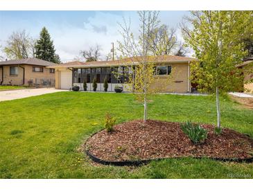 Charming single-story home with a well-maintained lawn and mature landscaping at 169 Emerald St, Broomfield, CO 80020