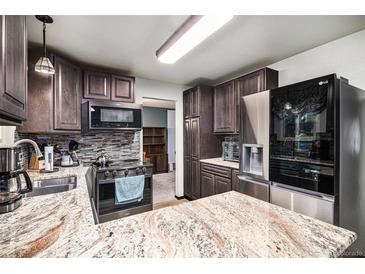 Modern kitchen features granite countertops and stainless steel appliances at 2652 S Sable Way, Aurora, CO 80014