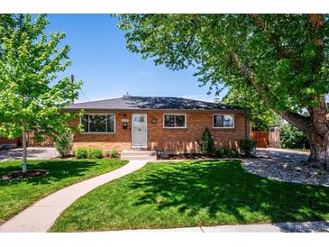 Charming brick home with well-maintained lawn and mature trees offering shade on a sunny day at 3145 W Farmdale Rd, Englewood, CO 80110